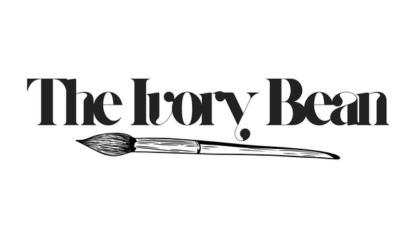 Logo of 'The Ivory Bean' with a brush illustration on a white background